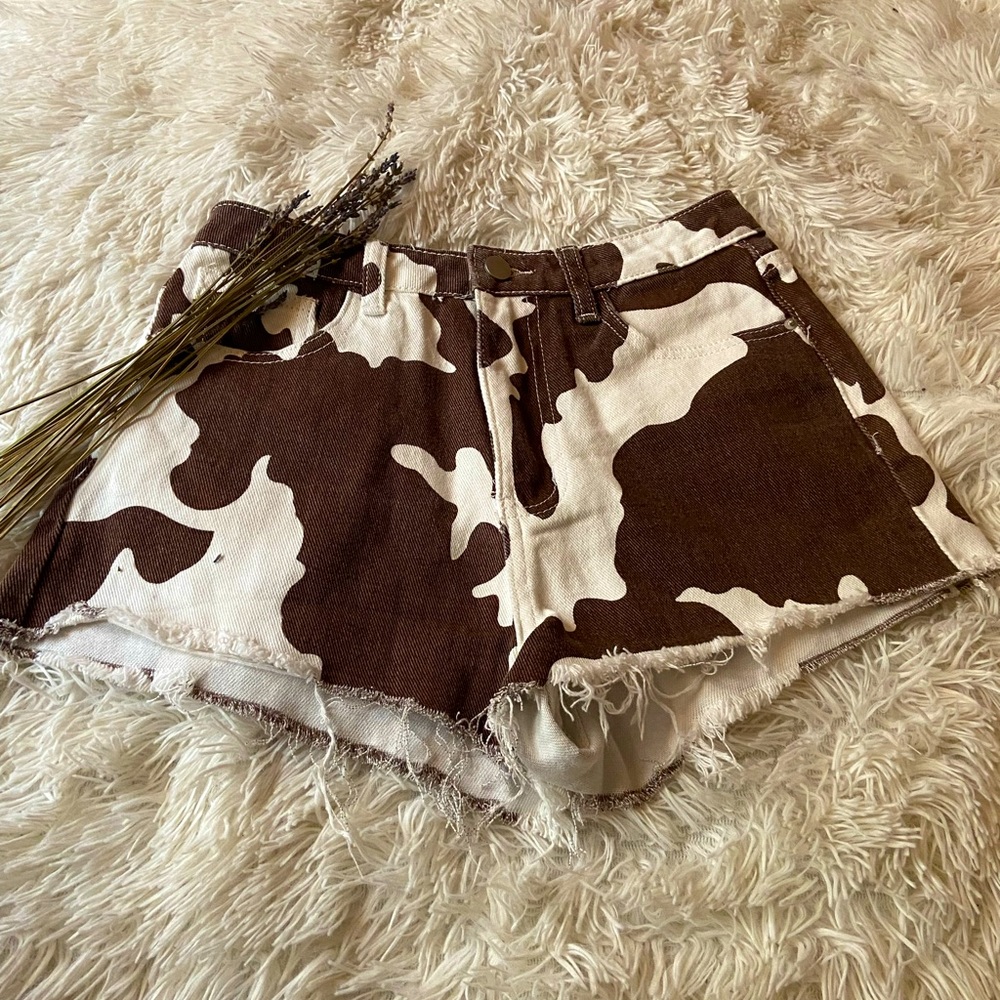 Cow print denim shorts.